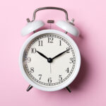 white clock on pink background